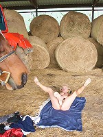 Mature slut playing with herself in a barn
